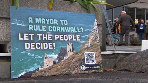 A protest sign in front of Cornwall County Hall in Truro, saying: "A mayor to rule Cornwall? Let the people decide!"