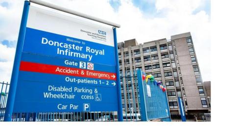 A hospital with signage in the foreground