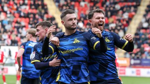 Doncaster Rovers' Luke Molyneux celebrates scoring his side's second goal with team-mates