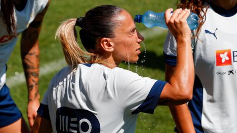 Portuguese player Tatiana Pinto pours water over her face during a training session
