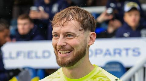 Conor Hazard, while playing for Plymouth Argyle, smiling as he walks out of the tunnel before a match.