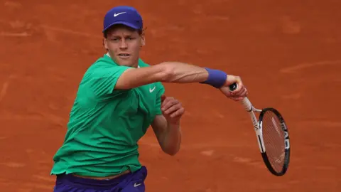 Jannik Sinner plays a forehand