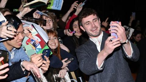 Paul Mescal takes a selfie with fans at the "Gladiator II" Irish Premiere 