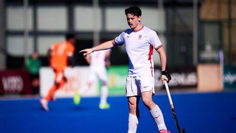 Henry Croft in action for England men's hockey team