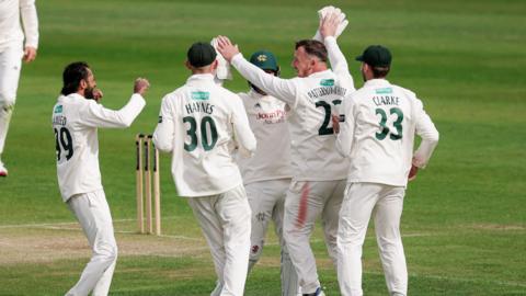 Nottinghamshire’s Liam Patterson-White celebrates with team-mates after taking the wicket of Yorkshire’s Adam Lyth for 44 runs