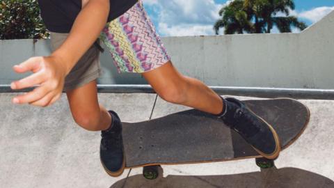 Child on skateboard on concrete ramp