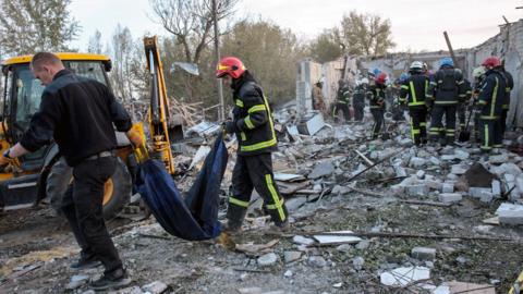 Rescuers work at the site of a military strike in the village of Hroza, Kupiansk district, Kharkiv region, northeastern Ukraine, on 5 October 2023, amid the Russian invasion