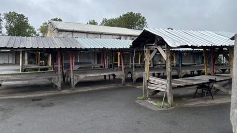Image shows empty market stalls at the Conran Street Market, which is set to be sold at auction 