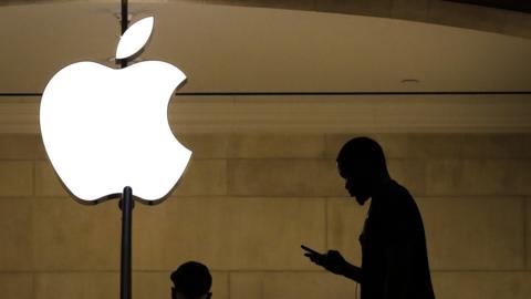 A man checks his phone in an Apple retail store in Grand Central Terminal, January 29, 2019 in New York City. Apple is set to report first-quarter earnings results after U.S. markets close on Tuesday.