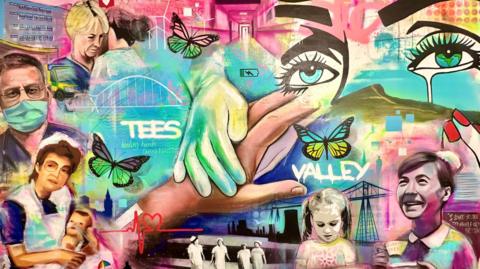 A mural of artwork depicting nurses, children and those working in healthcare. A gloved hand rests on another hand in the centre of the painting. The words "Tees Valley"  are displayed prominently.