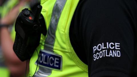 Side shot of police officer in Police Scotland uniform, showing chest and sleeve.