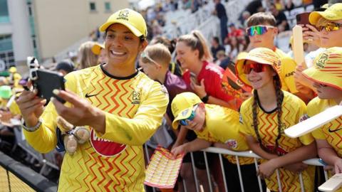 Sophia Dunkley smiles for a photo with young Trent Rockets fans