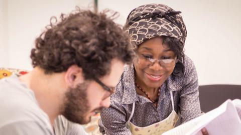 Jloy Kayembe from the Democratic Republic of Congo teaches a student French