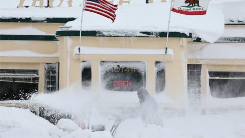 A man struggles to clear snow in Truckee, California. Photo: 2 March 2024