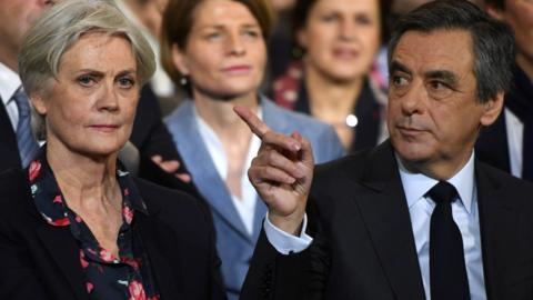 French right wing candidate for the upcoming presidential election Francois Fillon (R) flanked by his wife Penelope Fillon (L), during a campaign rally on 29 January 2017 in Paris