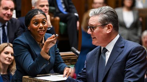 A split screen of Kemi Badenoch and Keir Starmer debating in the Commons