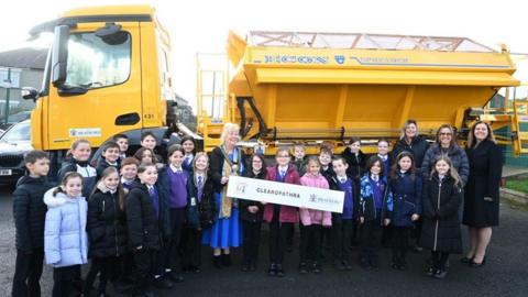 Pupils stood in front of one of the gritters 