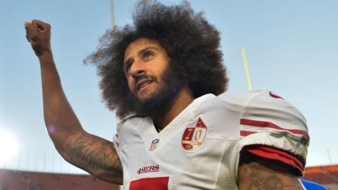 San Francisco 49ers quarterback Colin Kaepernick pumps his fist as he acknowledges cheers at Los Angeles Memorial Coliseum on December 24, 2016