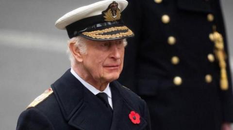 King Charles the Royal Navy uniform of the Admiral of the Fleet, with a red poppy brooch on his coat, during last year's Remembrance Sunday service at the Cenotaph in London