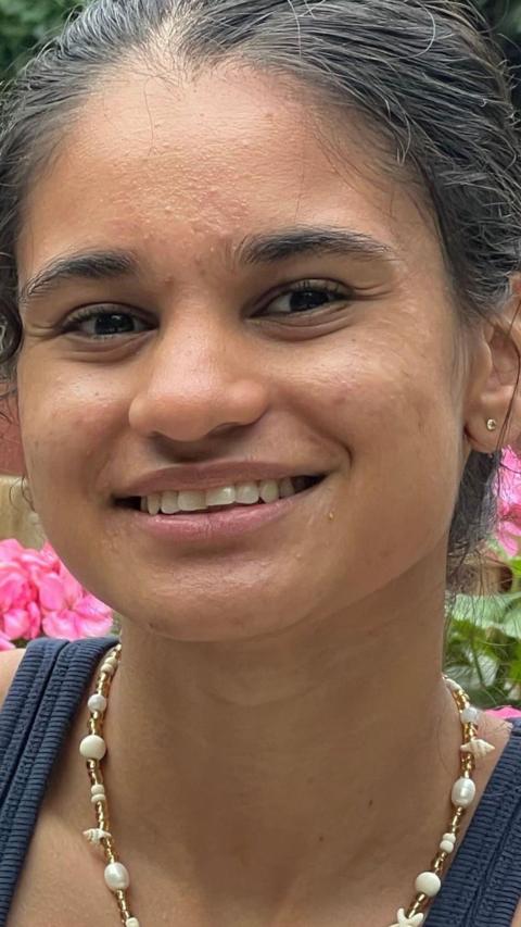 A young woman smiling at the camera