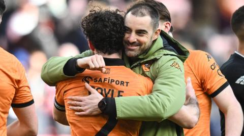 Hull City head coach Ruben Selles hugs player Lewie Coyle as they celebrate their win at Sunderland