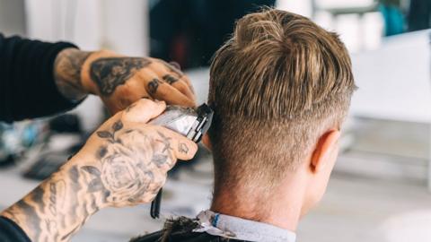 Portrait of a young man in a barbershop. Beauty and care for men. - stock photo