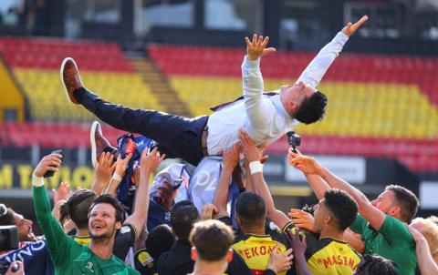 Watford players throw manager Xisco Munez into the air after securing promotion to the Premier League