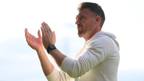 Luton Town manager Rob Edwards applauds the home fans after the Hatters' 1-1 draw with Wolverhampton Wanderers