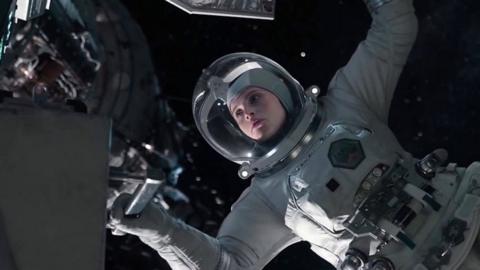 An in-post production shot from The Midnight Sky. Actress Felicity Jones is wearing a space suit