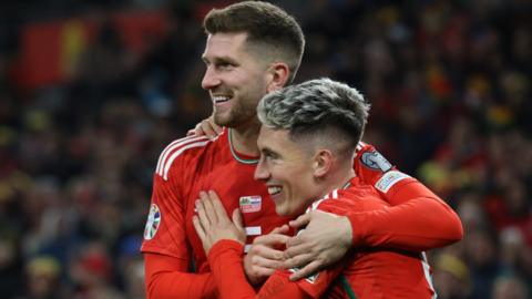 Harry Wilson of Wales (front) is congratulated by his team-mate Chris Mepham