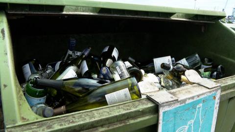 Glass bottles in a glass recycling bin at Salerie Corner, Guernsey