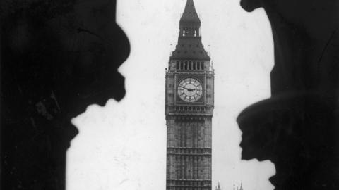 Big Ben pictured behind silhouettes of buildings in 1922