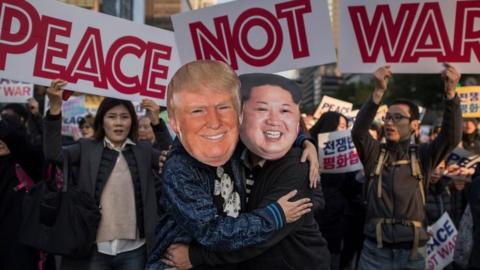 Demonstrators dressed as North Korean leader Kim Jong-Un (R) and US President Donald Trump (L) embrace during a peace rally in Seoul on November 5, 2017