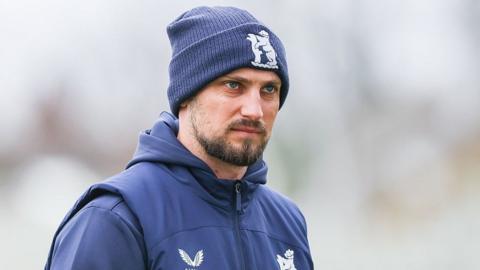 Warwickshire captain Ed Barnard wearing blue club beanie and blue training shirt and gilet