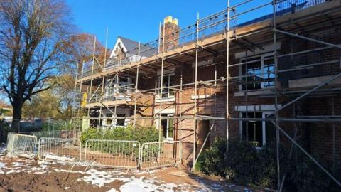 A building with scaffolding surrounding it. 