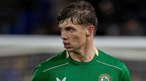 Conor McManus playing for Republic of Ireland Under-21s on a rainy night