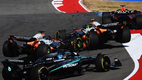 The McLarens of Lando Norris and Oscar Piastri collide at the first corner of the United States Grand Prix sprint race