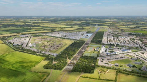 A CGI aerial view of a new housing development, with a runway running through the middle and three wind turbines at the end 