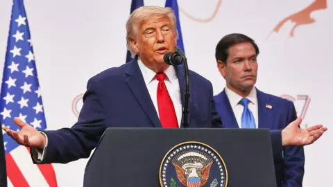 U.S. President Donald Trump holds a press conference on the final day of the summit, with U.S. Secretary of State Marco Rubio in the background on 17 June 2026