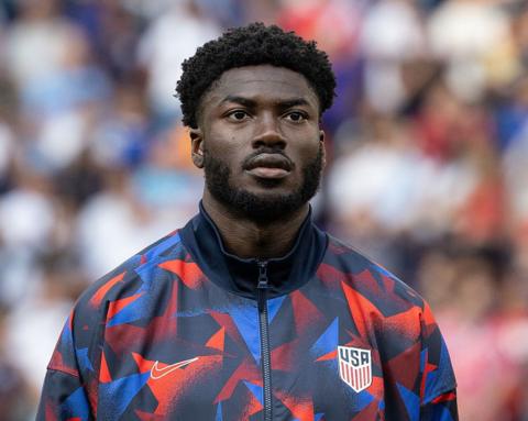 Patrick Agyemang stands for the national anthem