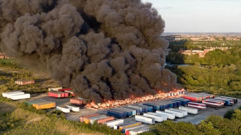 Fire engulfing several lorry trailers