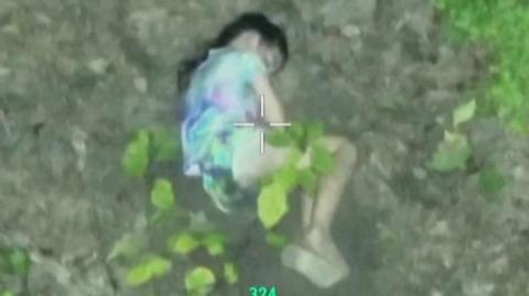 A girl is seen through a thermal drone lens, sleeping on the ground