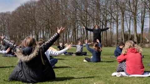 Rebekka Hjorth holds a music lesson outdoors with her class at the Korshoejskolen school on 15 April