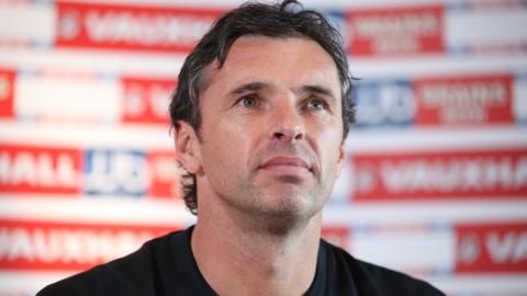 Gary Speed speaks to the media while Wales manager