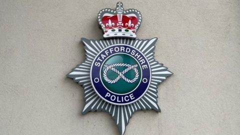 A Staffordshire Police emblem on a pale-coloured wall