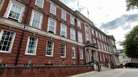 A large three-storey red brick building.