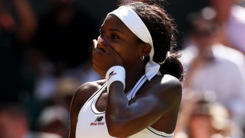 Coco Gauff covers her mouth with her hand after beating Jessica Pegula