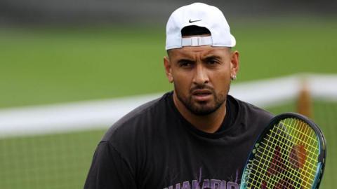 Nick Kyrgios holding a tennis racquet 