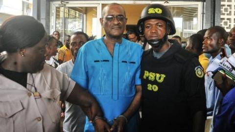 Charles Sirleaf (centre) is escorted outside from a court in Monrovia, Liberia. Photo: 4 March 2019