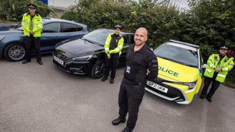 Greater Manchester Police with police vehicles